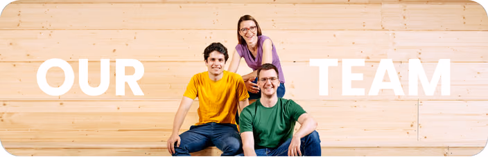 The macu4 team of three co-founders poses together against a wooden background