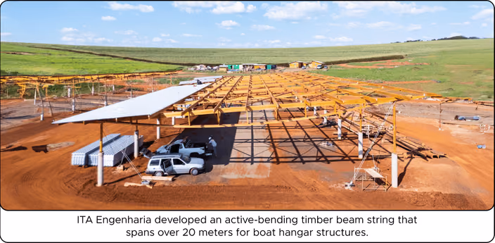 ITA Engenharia’s construction site showing active-bending tropical hardwood timber beam structure spanning 20 meters for a boat hangar