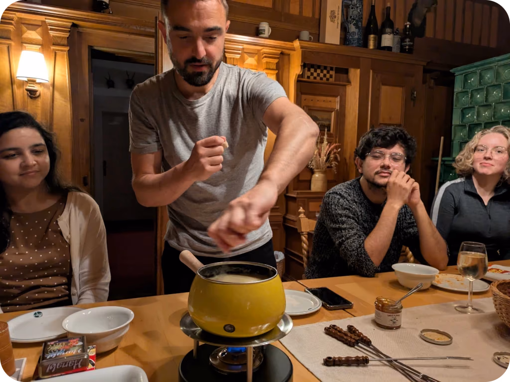 Mathieu cooking fondue for the team at the 2025 retreat