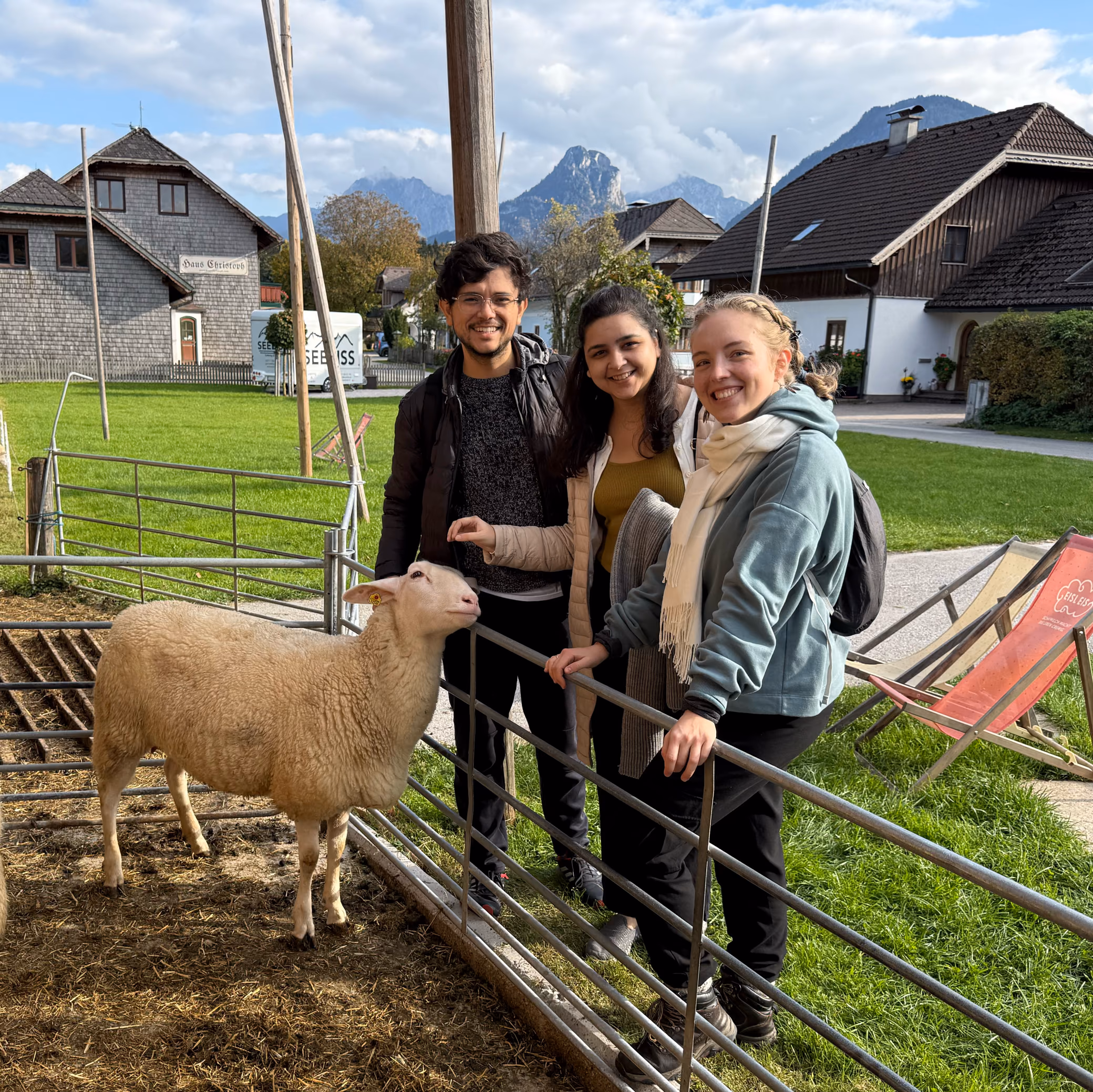 From left, Edwin, Sakshi and Agnieszka from the ShapeDiver Grasshopper team, petting a sheep at the 2025 team retreat at the Wolfgangsee, with mountains behind them